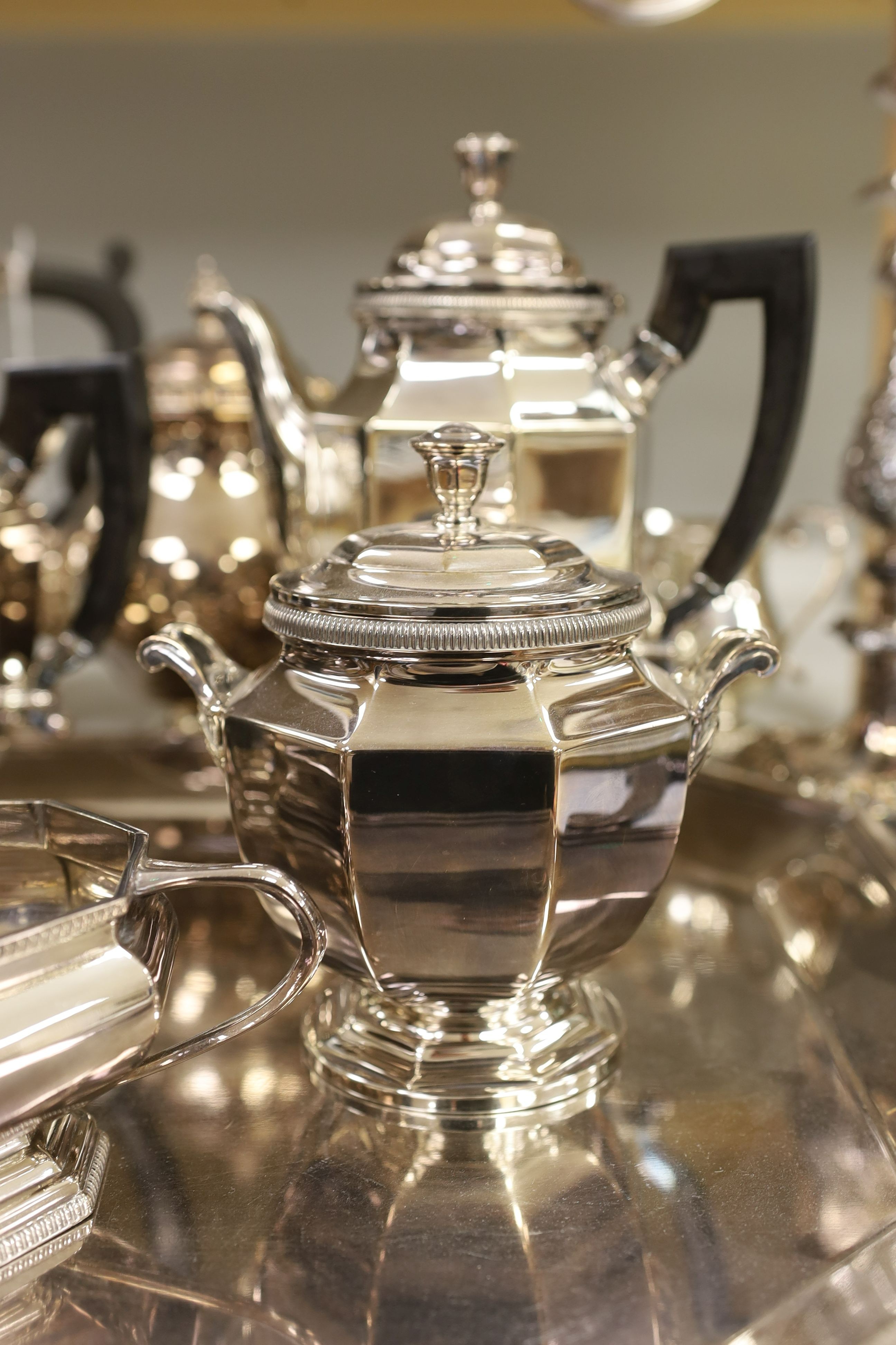 A French plated Cristofle tea set, together with other plated tea wares and a candelabrum